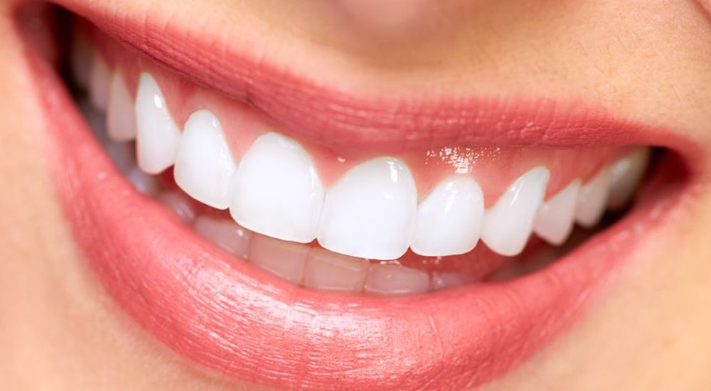 22208793 - dentist doing a dental treatment on a female patient
